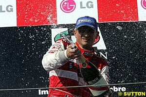 Winner Gabriele Tarquini sprays the champagne