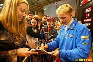 2003 World Rally Champion Petter Solberg signing autographs at a motorsport show earlier this month