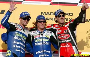 Second place finisher Colin Edwards, winner Sete Gibernau and third place finisher Ruben Xaus celebrate on the Qatar podium