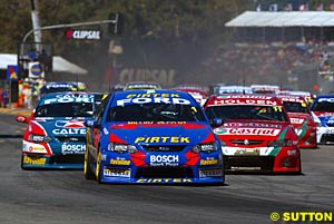 Marcos Ambrose leads the field into turns one and two at the start of the second race