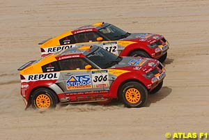 Mitsubishi's first and second place finishers run side by side on the last stage