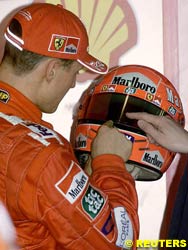 Schumacher inspects the Bell helmet, today