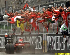 Ferrari crew rejoice as Schumacher wins
