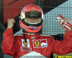 Michael Schumacher celebrates setting pole position, today