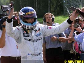 Mika Hakkinen celebrates taking pole position, today