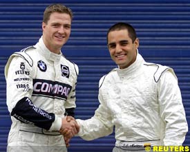 Ralf Schumacher and Juan Pablo Montoya shake hands during testing