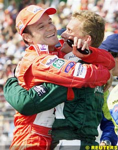 Barrichello gets a hug from his old teammate Herbert