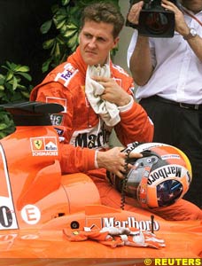 Schumacher sitting on his car after qualifying