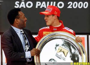 Soccer legend Pele presents Schumacher with his winners' plate