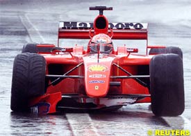 Michael Schumacher returns to the pits after his crash