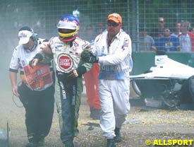 Villeneuve being aided away from his wrecked car